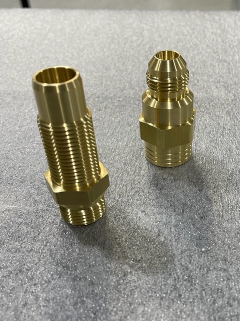 CNC-turned brass fitting machined by Mikron Manufacturing