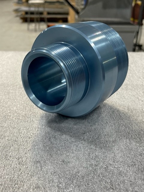 Anodized CNC-turned fitting produced by Mikron Manufacturing